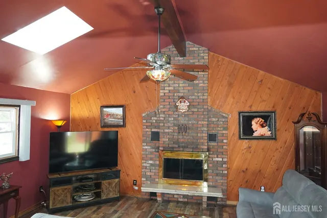 a living room with fireplace furniture and a flat screen tv