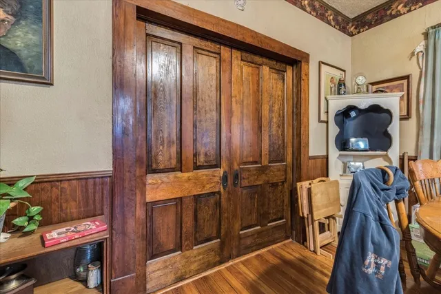 a bedroom with a bed and dresser with mirror