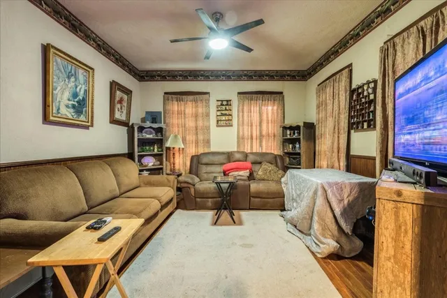 a bedroom with furniture and a large window