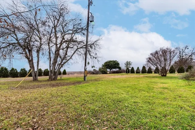 a view of backyard with wooden fence