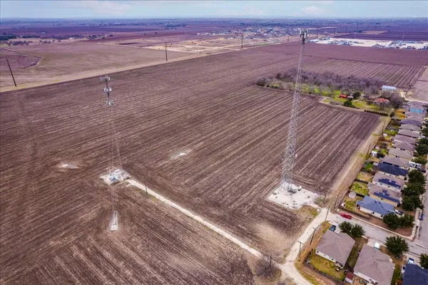 an aerial view of residential houses with city view