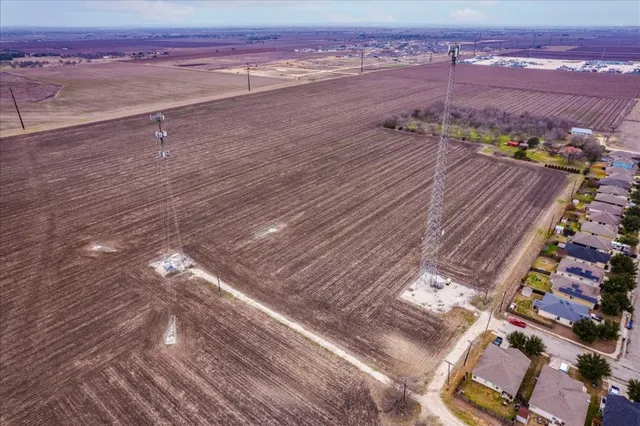 an aerial view of residential houses with city view