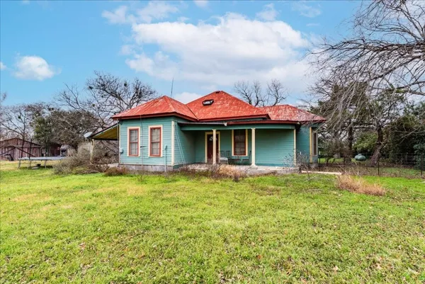 a kitchen with refrigerator and cabinets