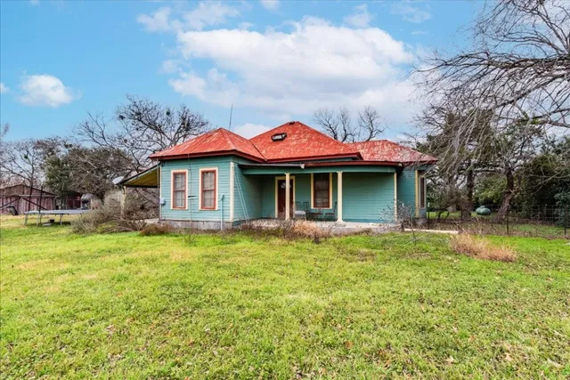 a kitchen with refrigerator and cabinets