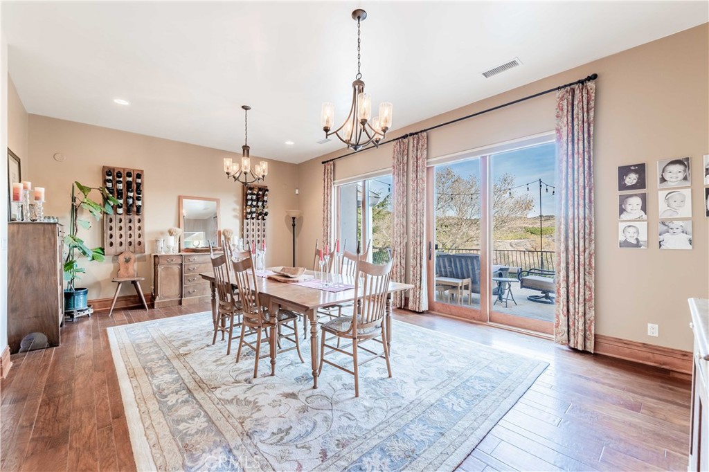 26525 Carancho Road Temecula, CA 92590 - Photo 12 of 64 a view of a dining room with furniture window and wooden floor