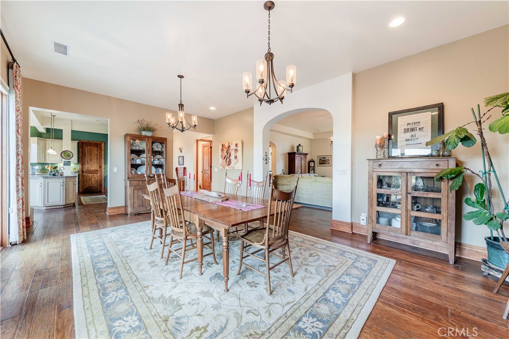 26525 Carancho Road Temecula, CA 92590 - Photo 14 of 64 a view of a dining room with furniture and wooden floor