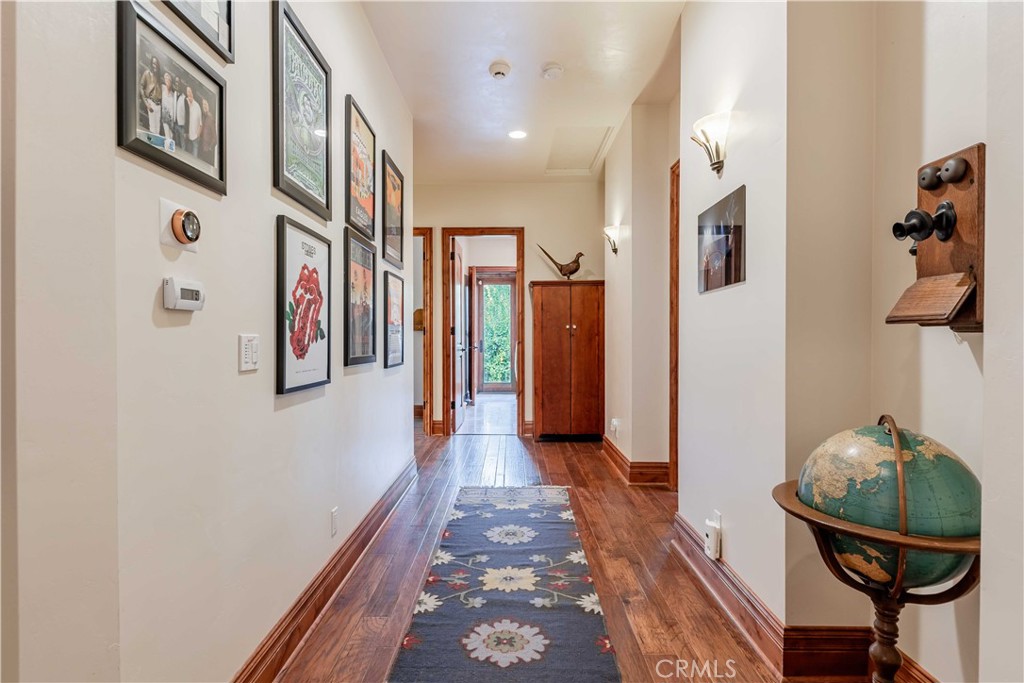 26525 Carancho Road Temecula, CA 92590 - Photo 23 of 64 a hallway with a dining table and chairs