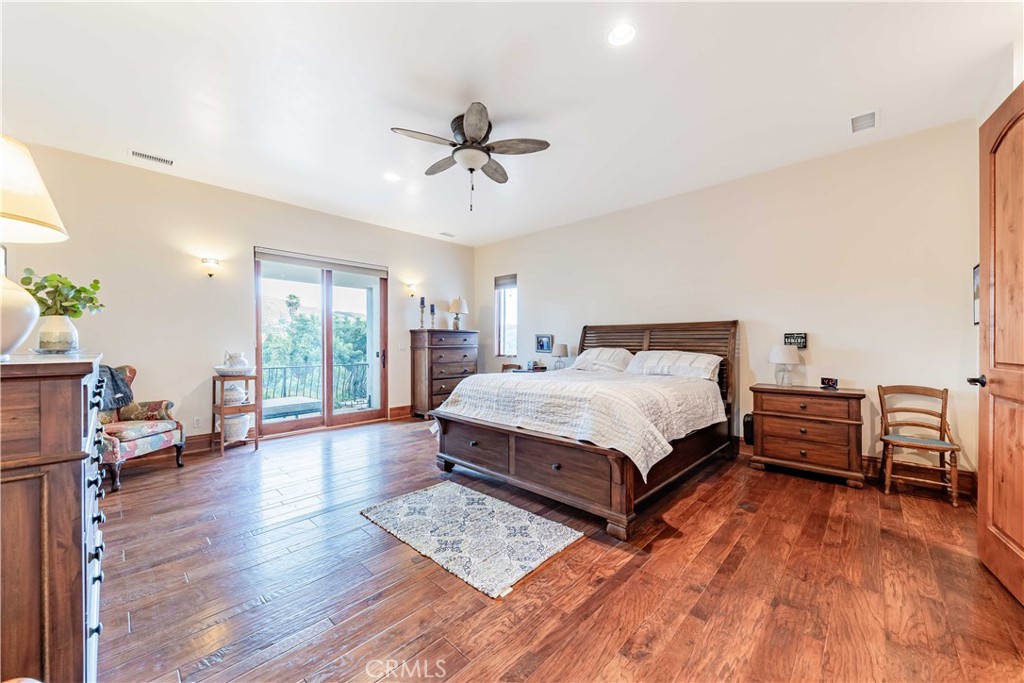 26525 Carancho Road Temecula, CA 92590 - Photo 24 of 64 a bedroom with a bed wooden floor and window