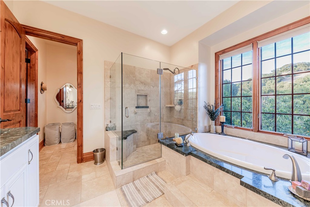 26525 Carancho Road Temecula, CA 92590 - Photo 28 of 64 a spacious bathroom with a tub mirror and shower