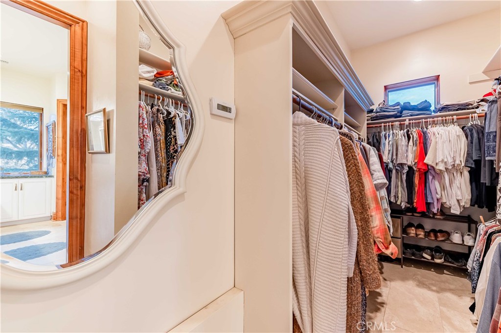 26525 Carancho Road Temecula, CA 92590 - Photo 29 of 64 a view of walk in closet with clothes and shoes