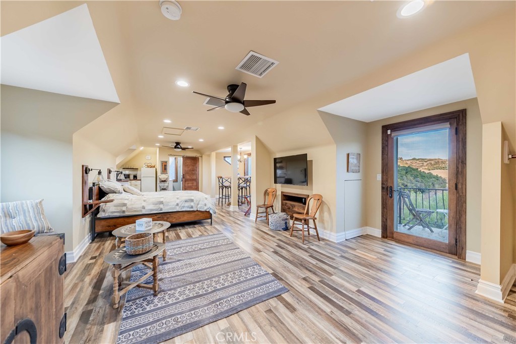26525 Carancho Road Temecula, CA 92590 - Photo 35 of 64 a living room with furniture a flat screen tv and a floor to ceiling window