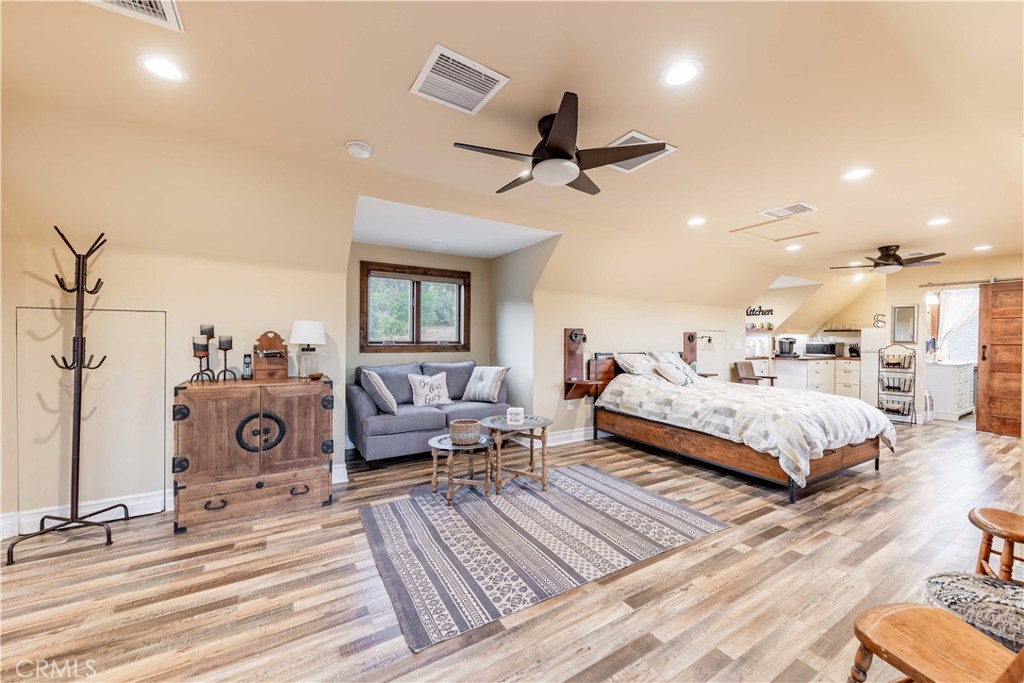 26525 Carancho Road Temecula, CA 92590 - Photo 36 of 64 a bedroom with a bed and wooden floor