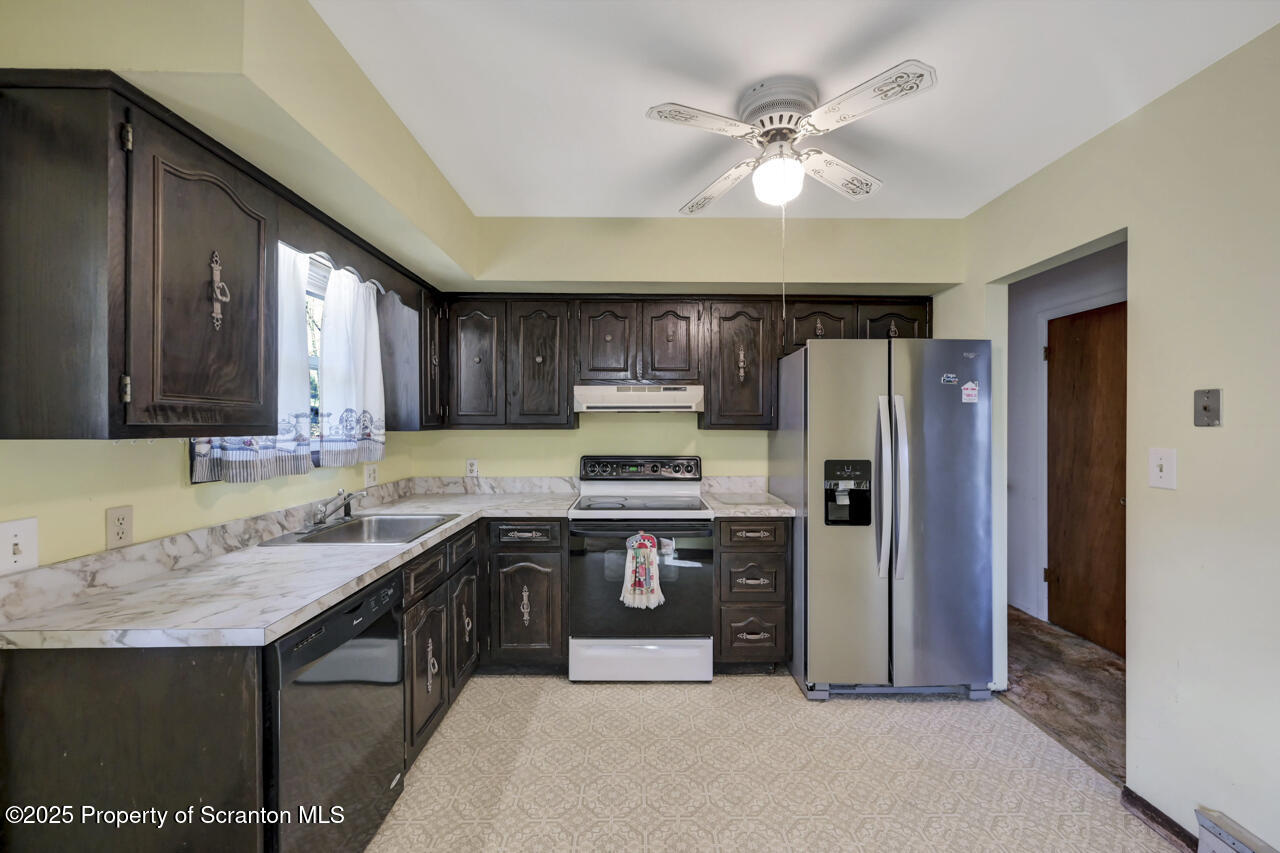 446 Maple Grove Road Moscow, PA 18444 - Photo 17 of 51 a kitchen with stainless steel appliances granite countertop a stove a refrigerator and a sink