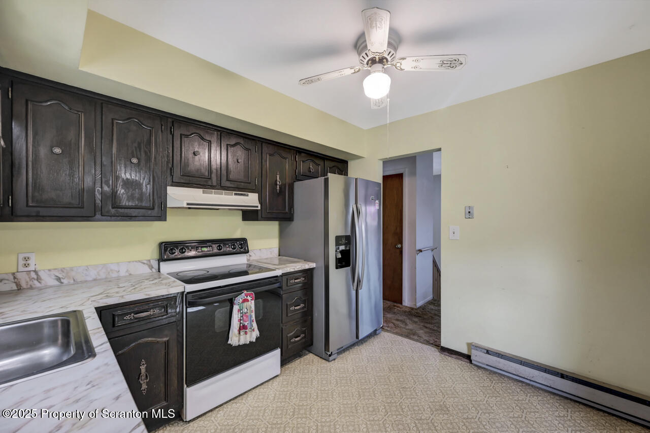 446 Maple Grove Road Moscow, PA 18444 - Photo 18 of 51 a kitchen with stainless steel appliances granite countertop a stove a refrigerator and a sink