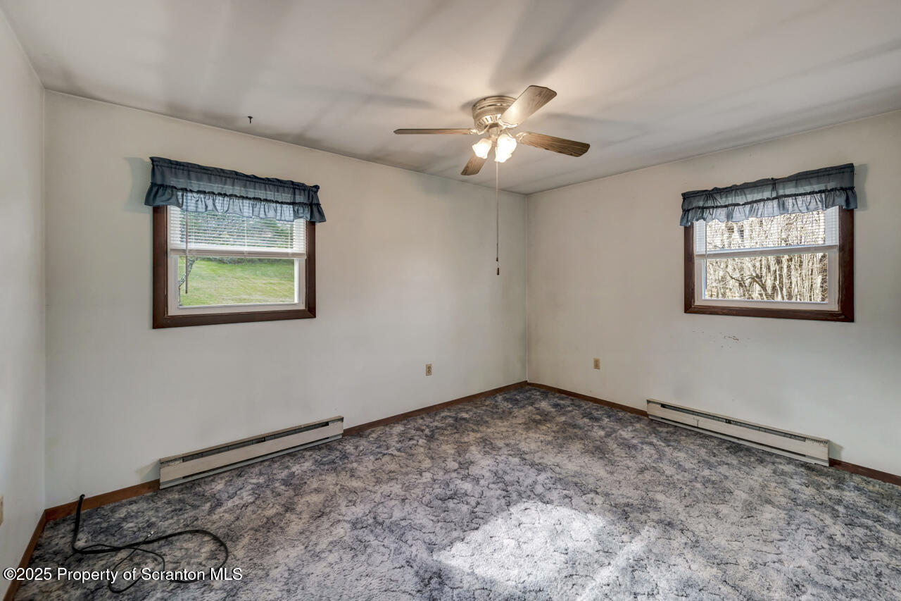 446 Maple Grove Road Moscow, PA 18444 - Photo 24 of 51 a view of a big room with window and ceiling fan