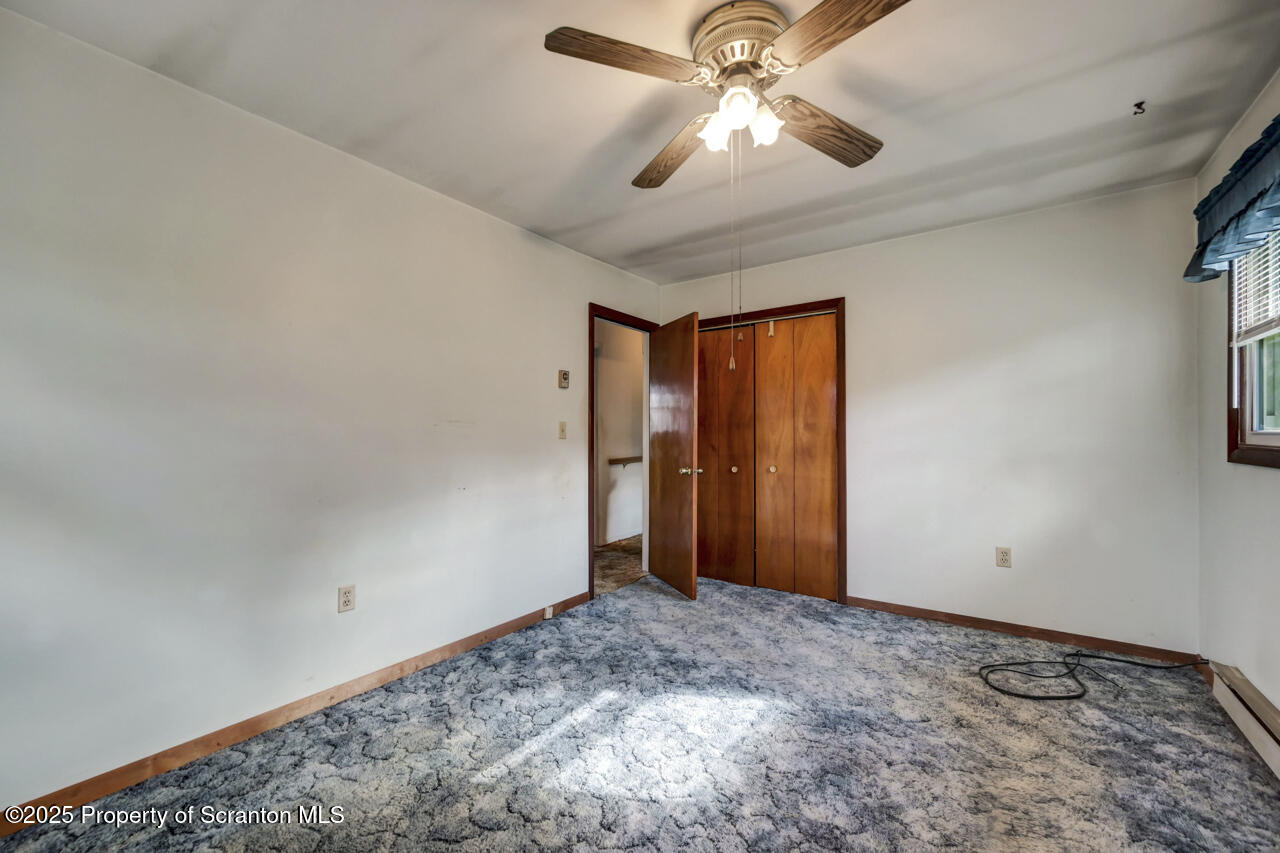 446 Maple Grove Road Moscow, PA 18444 - Photo 26 of 51 an empty room with a ceiling fan and a window
