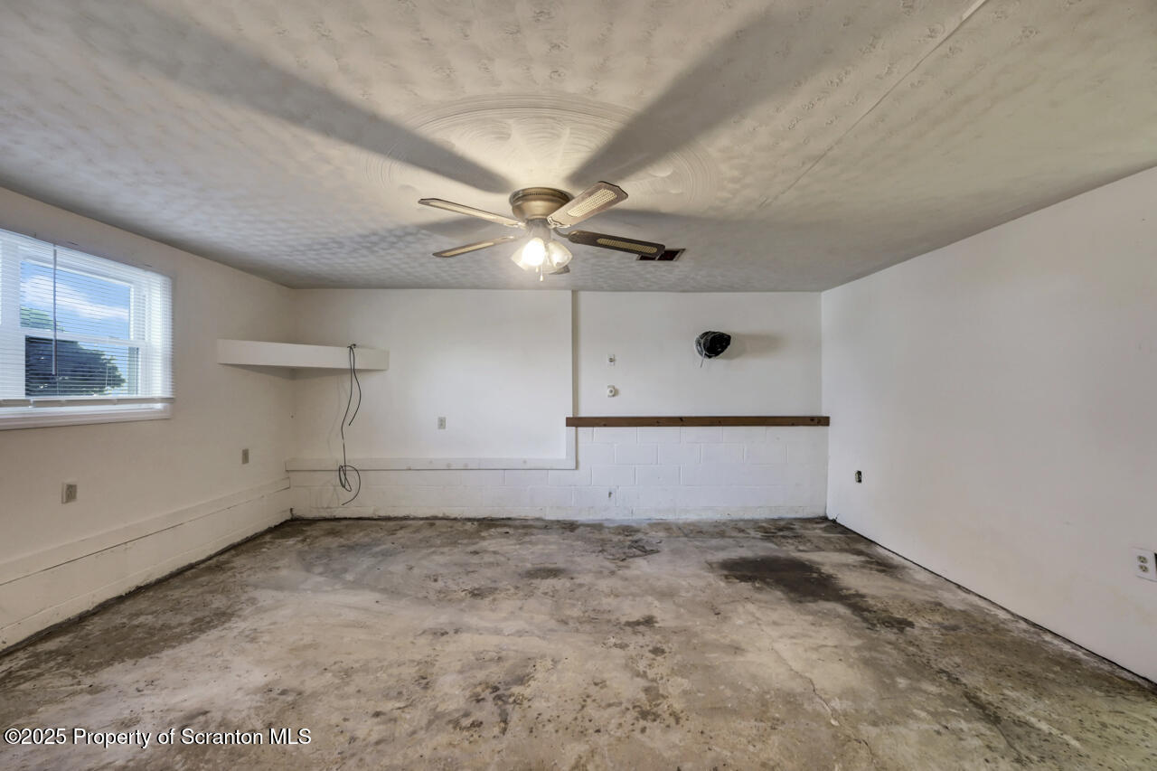 446 Maple Grove Road Moscow, PA 18444 - Photo 37 of 51 an empty room with a ceiling fan and window