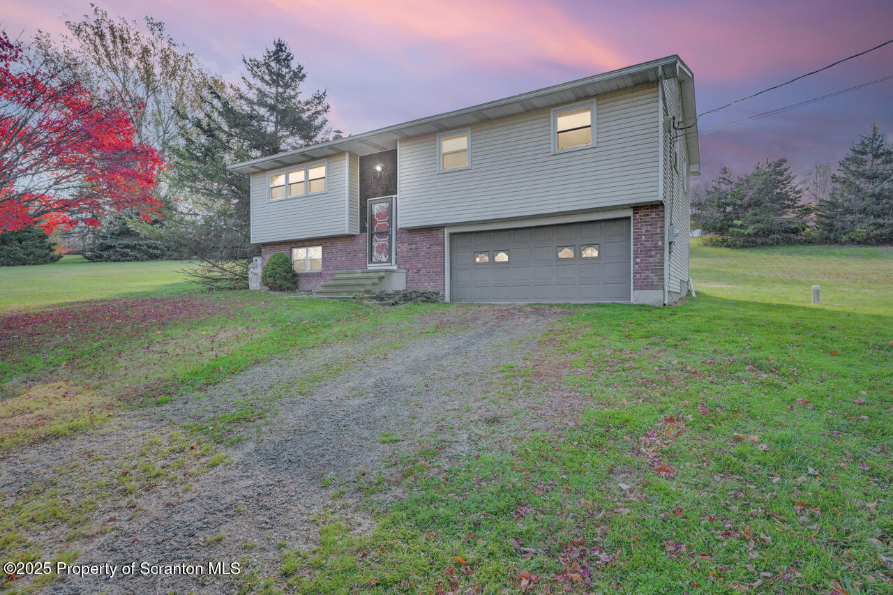 446 Maple Grove Road Moscow, PA 18444 - Photo 4 of 51 a brick building with a yard