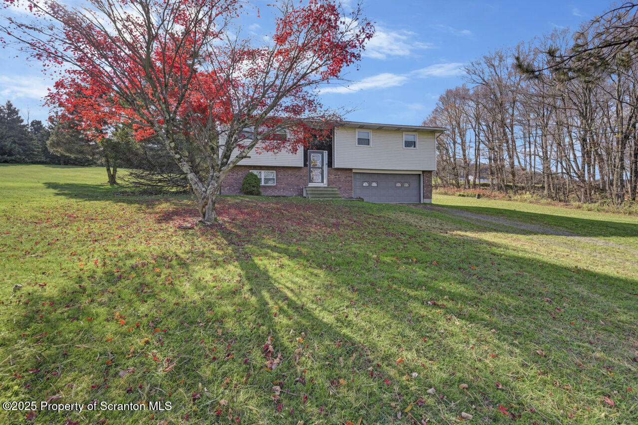446 Maple Grove Road Moscow, PA 18444 - Photo 5 of 51 a view of a big house with a big yard and large trees