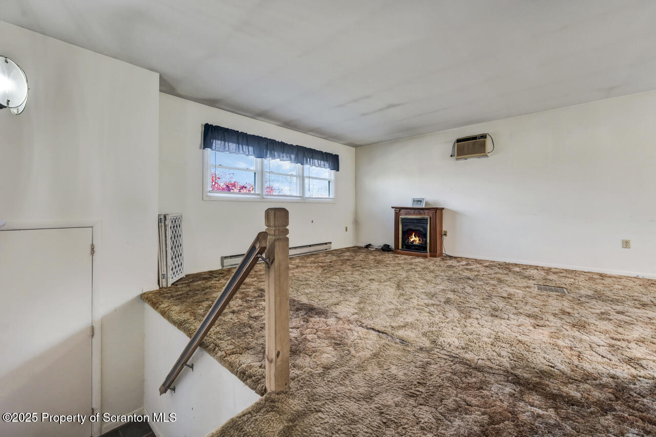 446 Maple Grove Road Moscow, PA 18444 - Photo 9 of 51 a bedroom with a bed and a chandelier