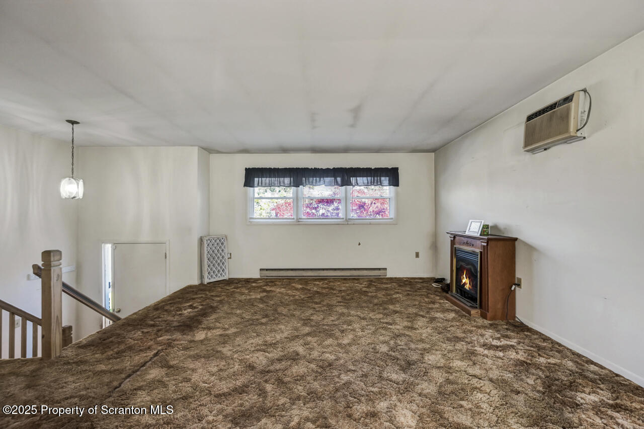 446 Maple Grove Road Moscow, PA 18444 - Photo 10 of 51 a view of a livingroom with a ceiling fan and window