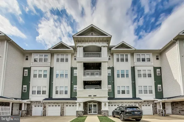 a front view of a residential apartment building with a yard