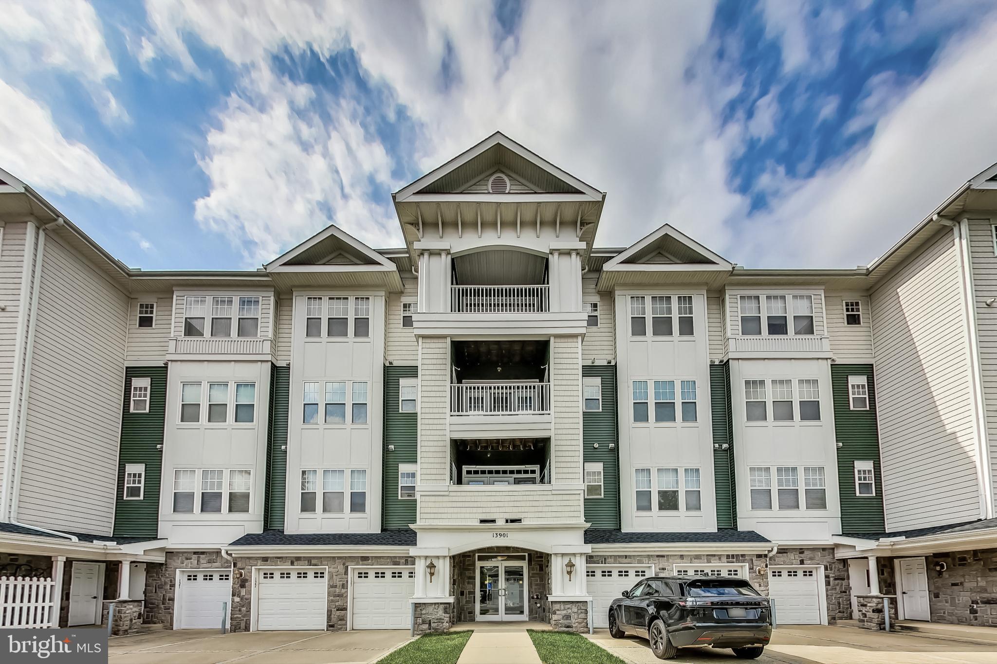 a front view of a residential apartment building with a yard