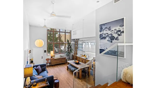 a living room with furniture and kitchen view
