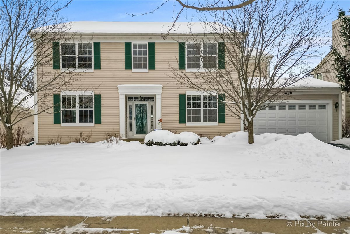 a view of a house with a snow in the yard