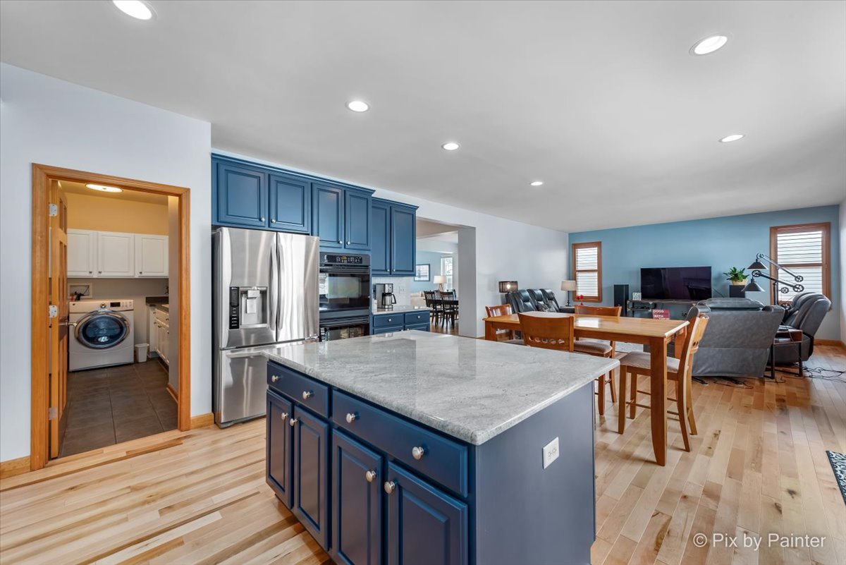 488 Newcastle Drive Cary, IL 60013 - Photo 15 of 33 a kitchen with stainless steel appliances granite countertop a refrigerator and a stove top oven