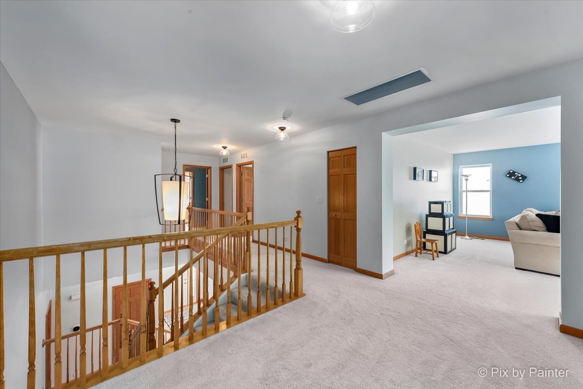 488 Newcastle Drive Cary, IL 60013 - Photo 18 of 33 a view of a hallway with dining room and furniture