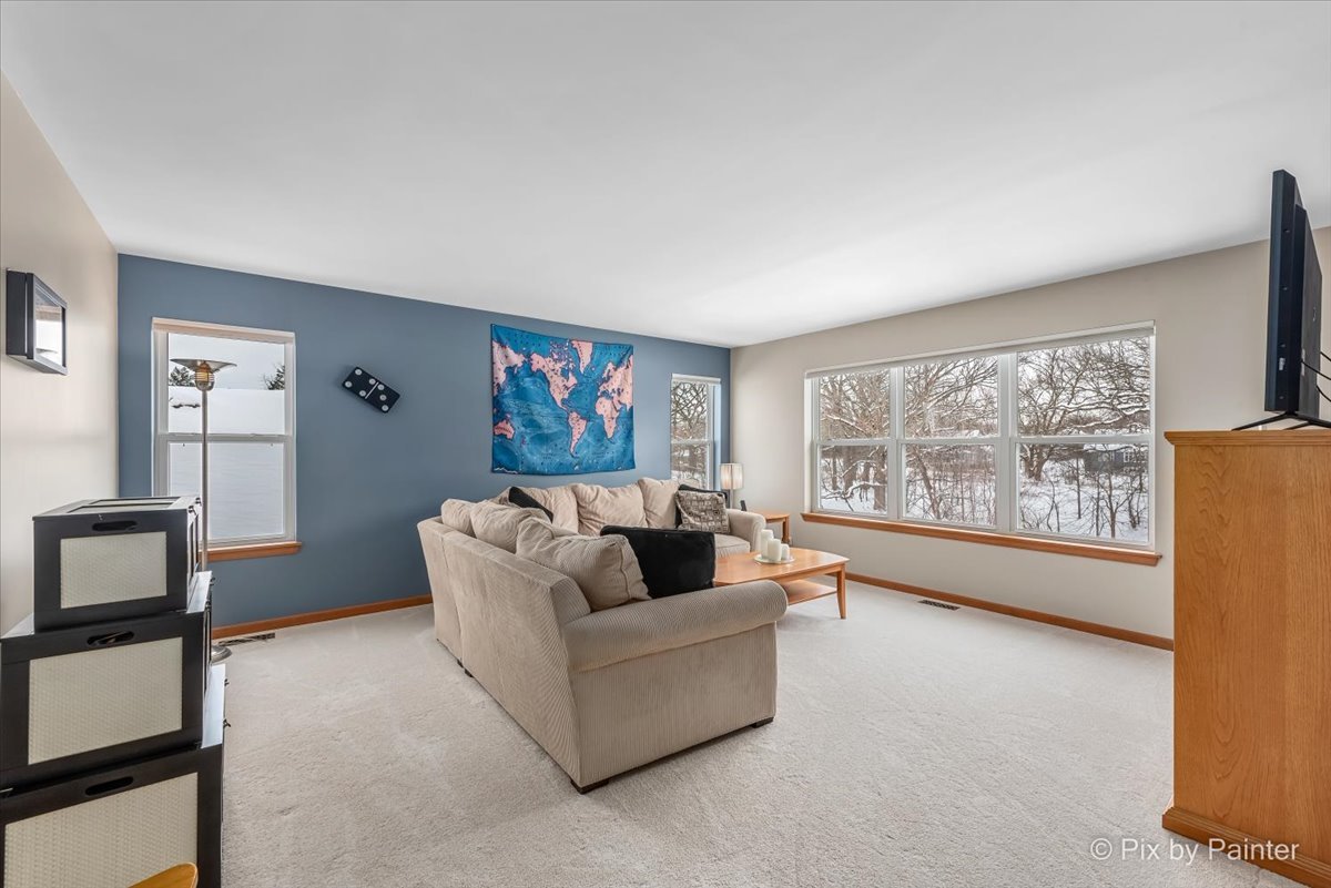 488 Newcastle Drive Cary, IL 60013 - Photo 19 of 33 a living room with furniture and a large window