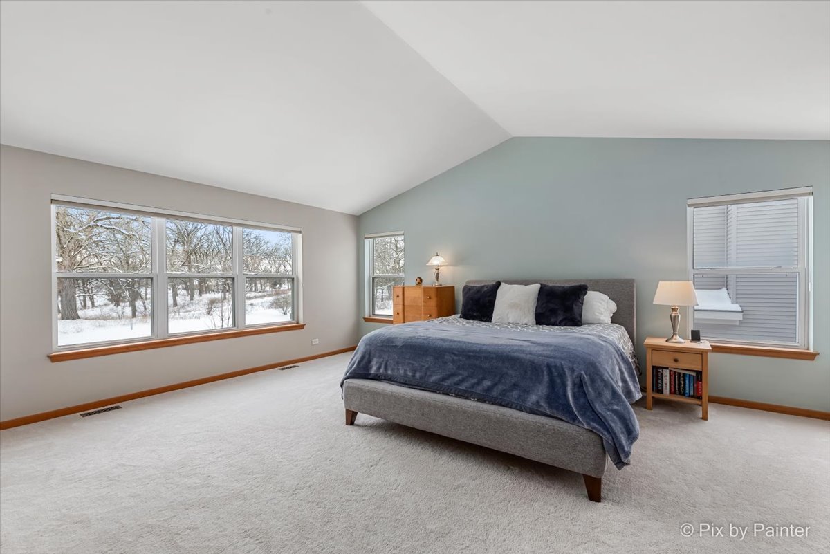 488 Newcastle Drive Cary, IL 60013 - Photo 21 of 33 a spacious bedroom with a bed lamp and window