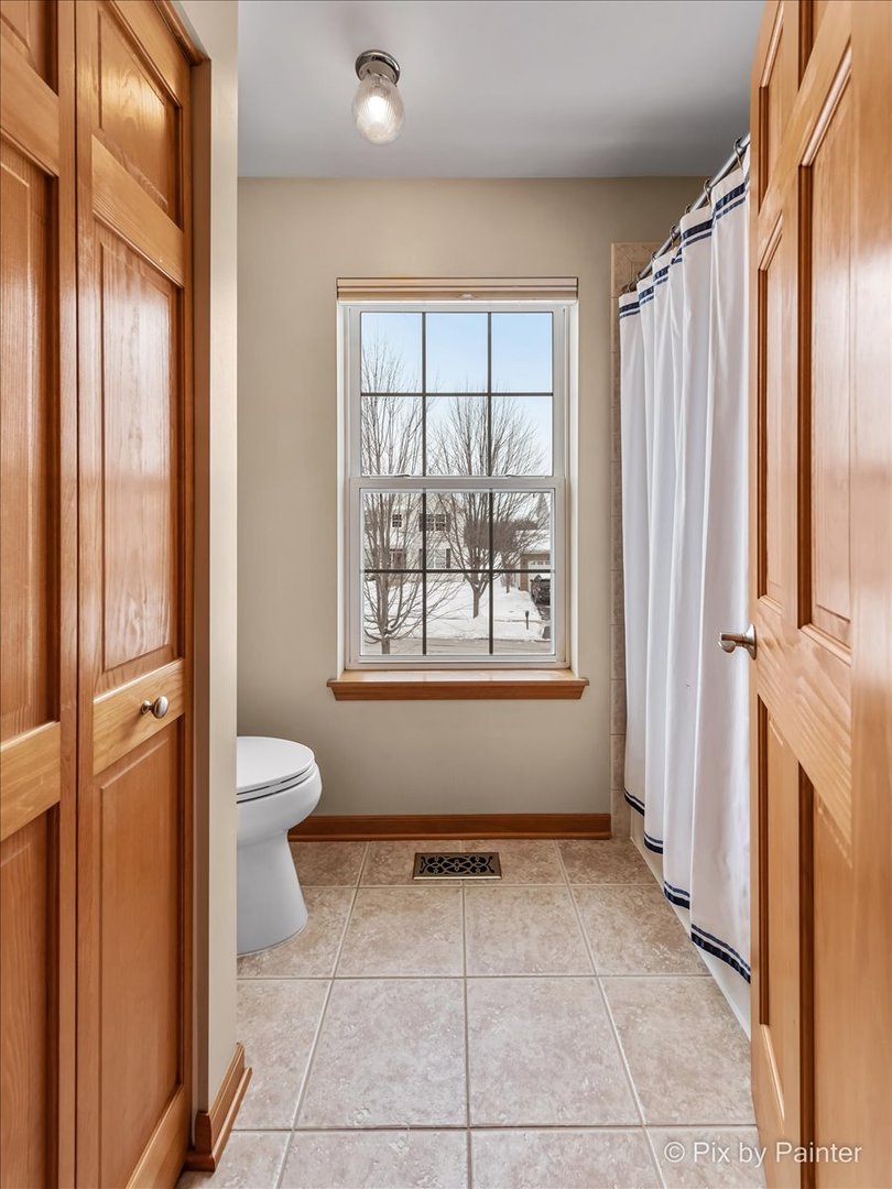 488 Newcastle Drive Cary, IL 60013 - Photo 29 of 33 a view of a bathroom with a toilet and a shower