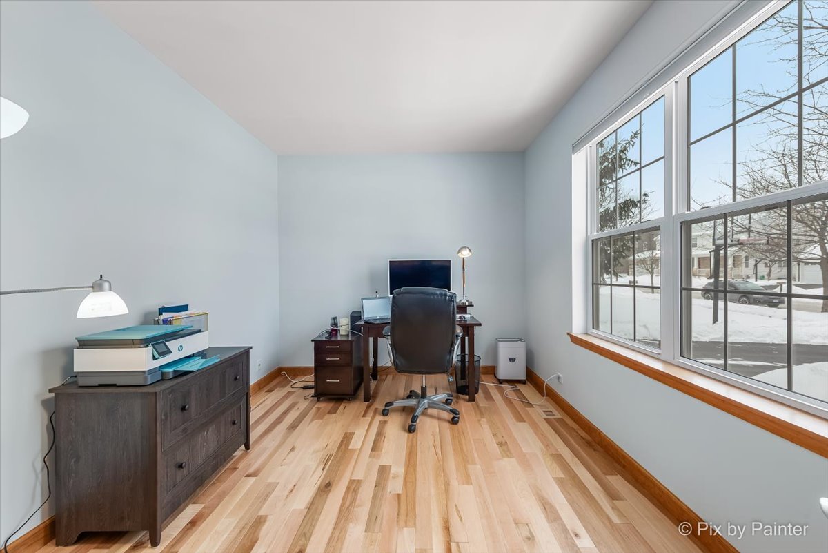 488 Newcastle Drive Cary, IL 60013 - Photo 3 of 33 a workspace with furniture a rug and a window