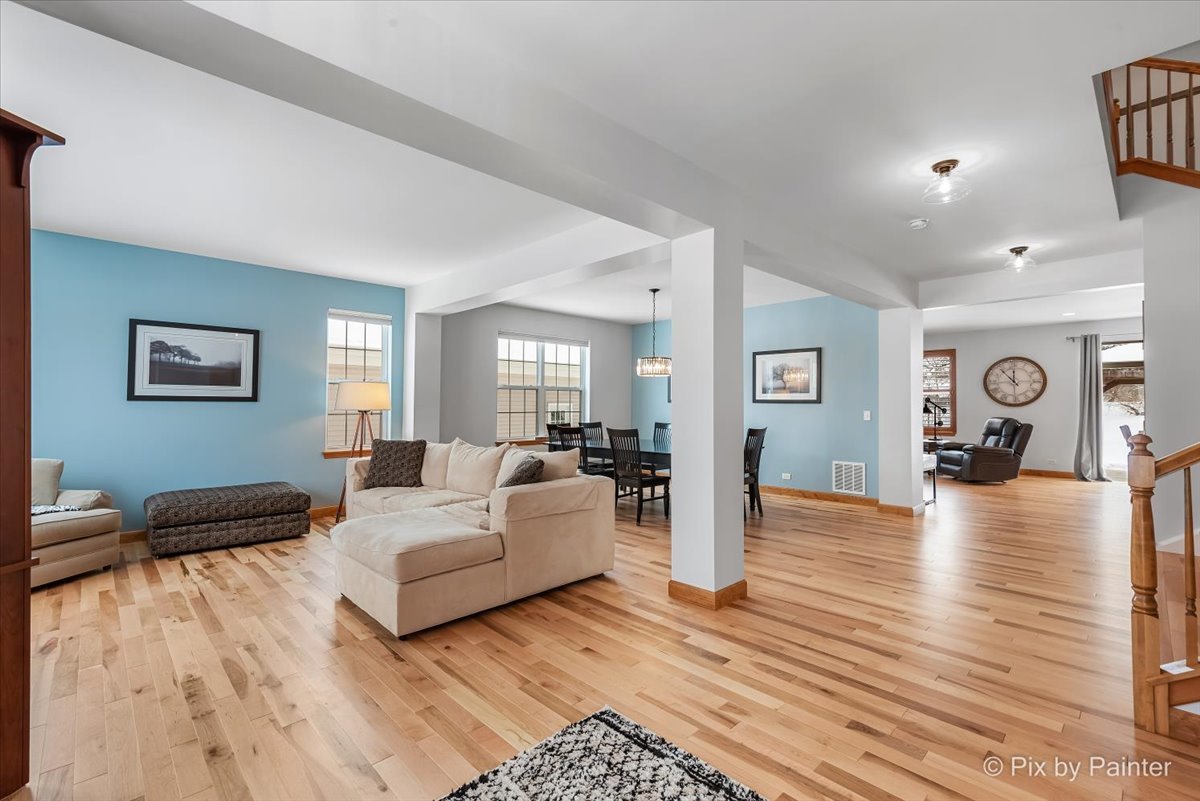 488 Newcastle Drive Cary, IL 60013 - Photo 4 of 33 a living room with furniture and a wooden floor