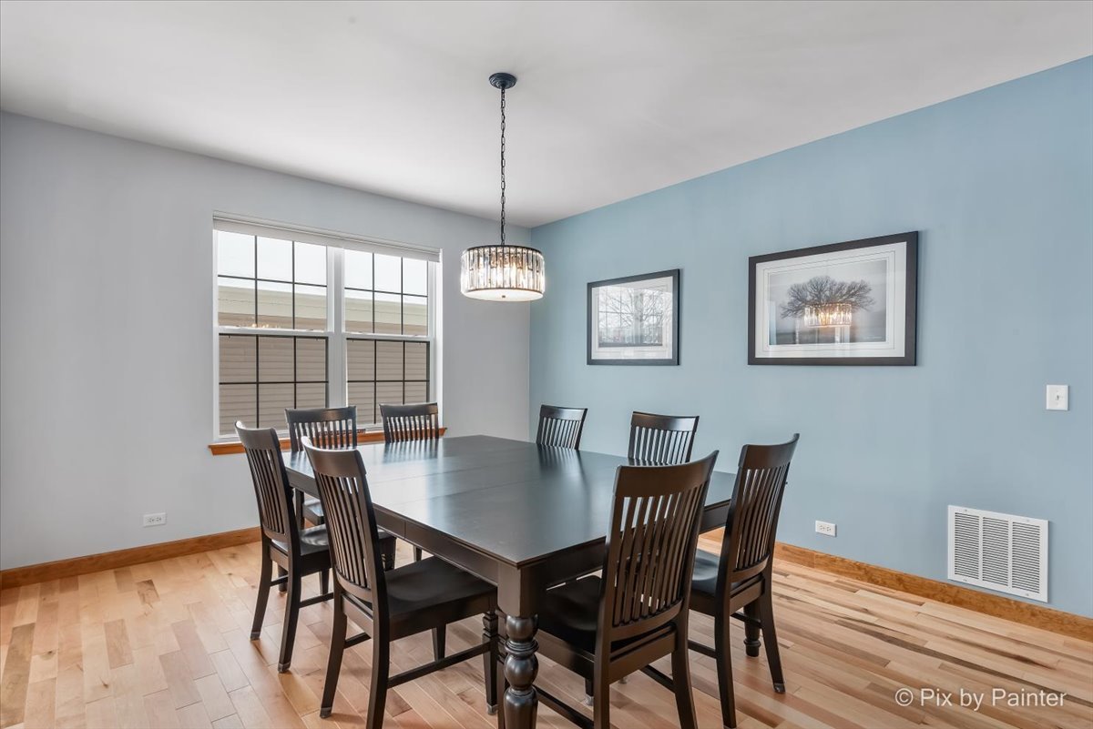 488 Newcastle Drive Cary, IL 60013 - Photo 7 of 33 a view of a dining room with furniture window and wooden floor