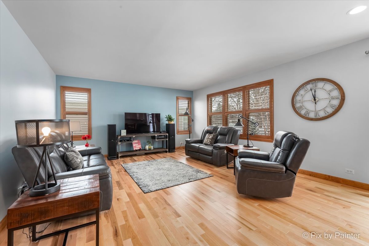 488 Newcastle Drive Cary, IL 60013 - Photo 10 of 33 a living room with furniture and a flat screen tv