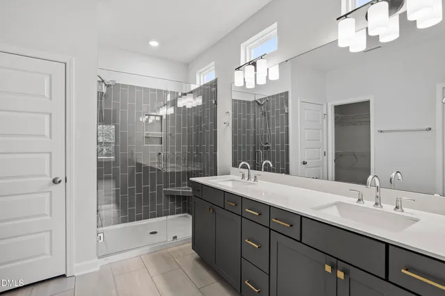 a bathroom with a shower sink and mirror