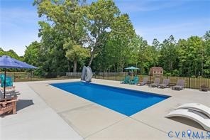8258 Mt Eagle Road Ashland, VA 23005 - Photo 14 of 14 a roof deck with table and chairs under an umbrella