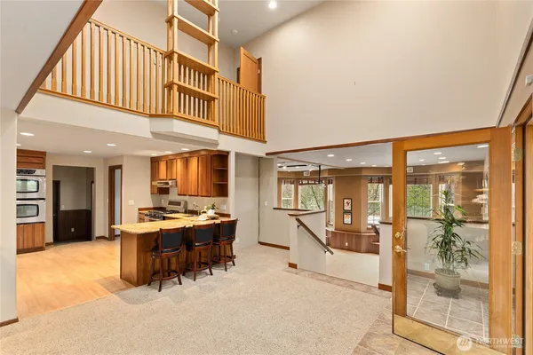 a living room with stainless steel appliances kitchen island granite countertop furniture and a kitchen view