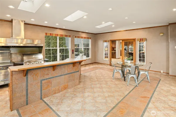 a dining room with furniture and a floor to ceiling window