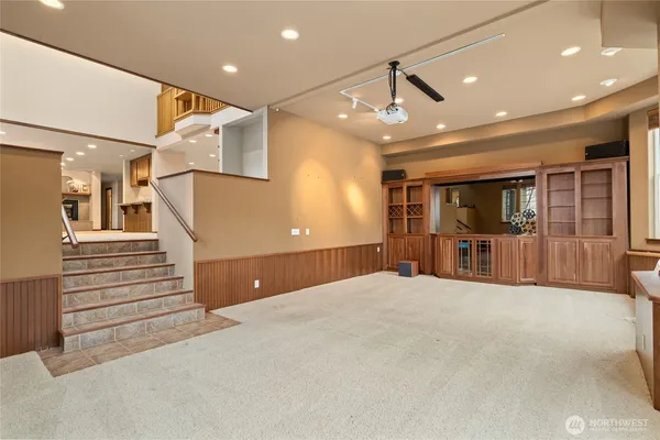 a view of an empty room with furniture and a window