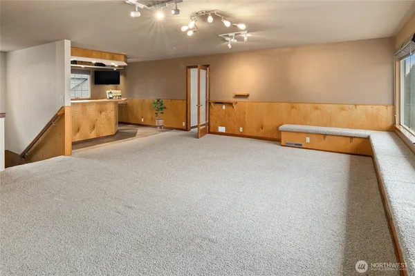 a dining hall with stainless steel appliances granite countertop a stove and a sink