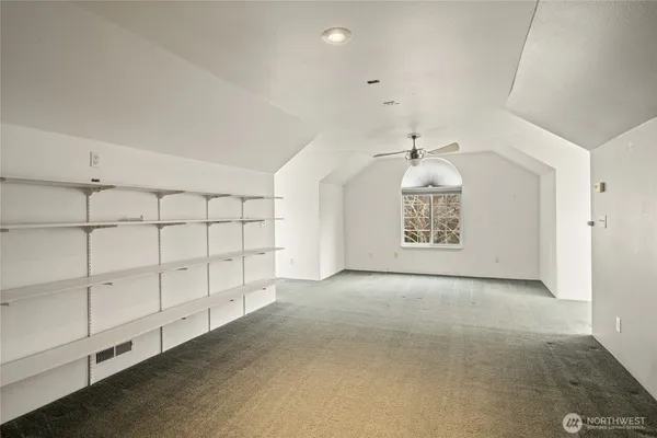 an empty room with windows and closet