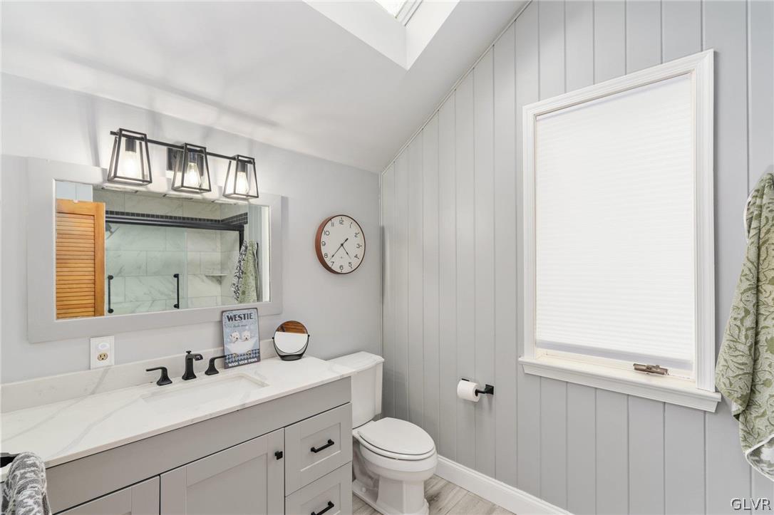 9325 Danner Road New Tripoli, PA 18066 - Photo 28 of 50 a bathroom with a toilet a sink a mirror and a window