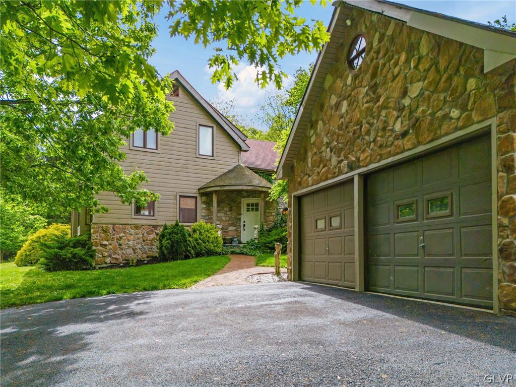 9325 Danner Road New Tripoli, PA 18066 - Photo 3 of 50 a front view of a house with a yard and garage