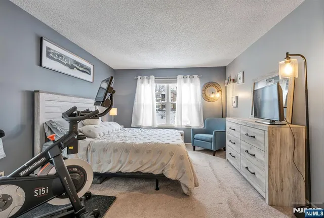 a bedroom with bed and a large mirror