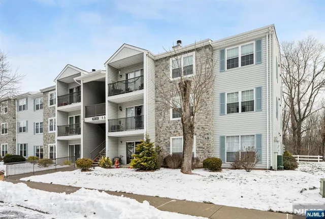 a front view of a building with a yard