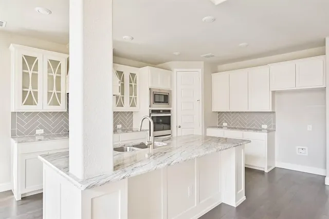 a kitchen with stainless steel appliances granite countertop a sink and cabinets